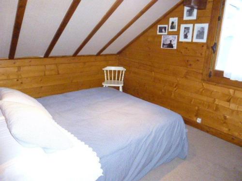 1 dormitorio con 1 cama blanca y 1 silla en Chalet Arette, 4 pièces, 6 personnes - FR-1-602-80, en Arette