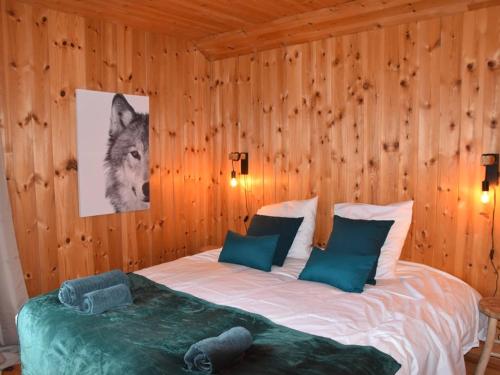 a bedroom with a wolf picture on the wall at Chalet Montgenèvre, 5 pièces, 10 personnes - FR-1-266-179 in Montgenèvre