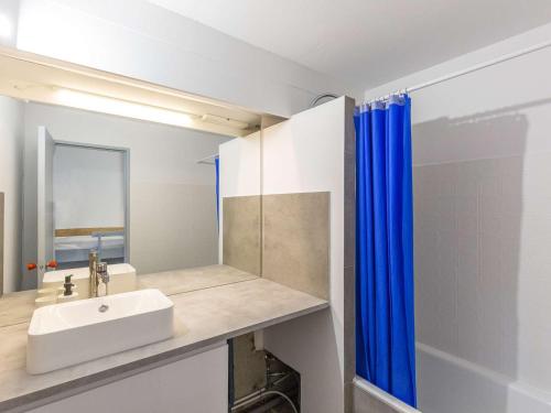 a bathroom with a sink and a mirror at Studio La Mongie, 1 pièce, 5 personnes - FR-1-404-334 in Bagnères-de-Bigorre