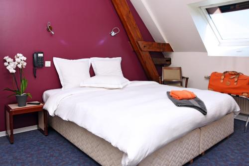 Uma cama ou camas num quarto em Au Tilleul