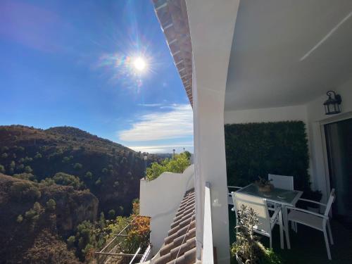 a view from the balcony of a house with a table at Mirador De La Axarquia in Frigiliana