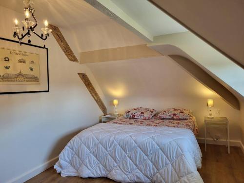une chambre avec un lit dans un grenier dans l'établissement Maison Familiale, Plage à 250m, Calme, Jardin, Terrasse, WIFI - FR-1-465-75, à Merville-Franceville-Plage