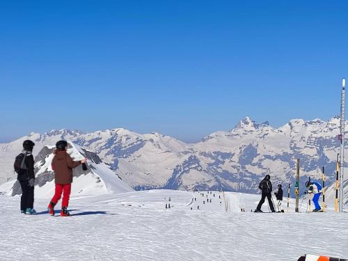 un grupo de personas de pie en una pista de esquí cubierta de nieve en Coquet Studio de 4 personnes aux Carroz - Balcon et Wifi, en Les Carroz d'Araches