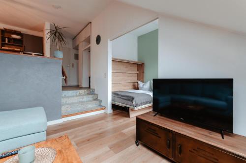 a living room with a large flat screen tv at CozyStay - Gemütliche Wohnung im Oberharz in Sankt Andreasberg