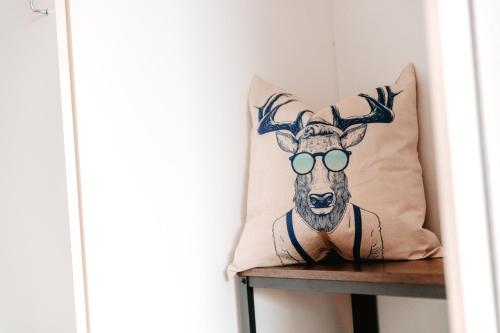a pillow with a deer with glasses on it at CozyStay - Gemütliche Wohnung im Oberharz in Sankt Andreasberg