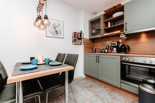 a kitchen with a wooden table and a dining room at CozyStay - Gemütliche Wohnung im Oberharz in Sankt Andreasberg