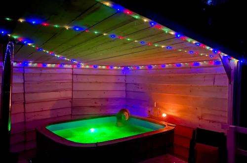 a jacuzzi tub with lights and a person in it at Domki w Górach Stołowych in Kudowa-Zdrój