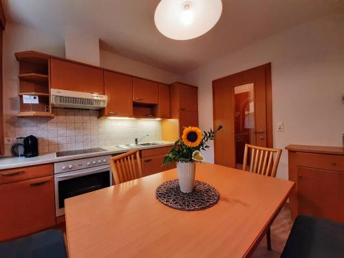 a kitchen with a table with a vase of flowers on it at Ferienwohnung Aschaber in Wildschönau