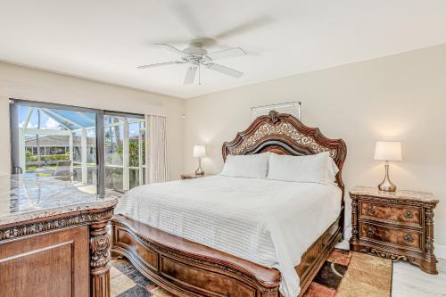a bedroom with a bed and a window at Menorca Court in Marco Island
