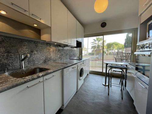une cuisine avec un évier et un lave-vaisselle dans l'établissement Charmant T2 avec terrasse, climatisé, centre-ville Antibes, proche mer et commerces - FR-1-252-177, à Antibes