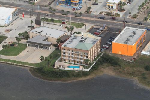 an aerial view of a building next to the water at Blue Bay Inn and Suites in South Padre Island