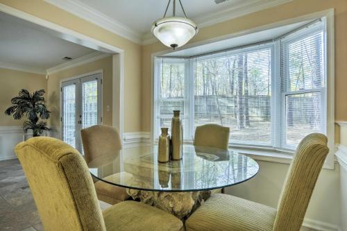 a dining room with a glass table and chairs at Raleigh Home Near Dining and Shops! in Raleigh