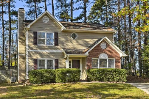 a house with trees in the background at Raleigh Home Near Dining and Shops! in Raleigh