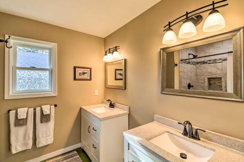a bathroom with a sink and a mirror at Brand New Cotter Home, Walk to Trout Fishing! in Cotter