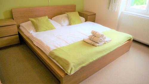 a bed with a stuffed teddy bear sitting on it at Resort Mlýn Karolínka in Vranov nad Dyjí