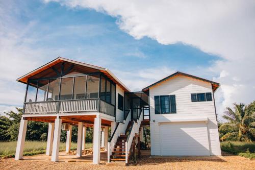 a large house with a garage in front of it at Almond Beach Resort at Jaguar Reef in Hopkins