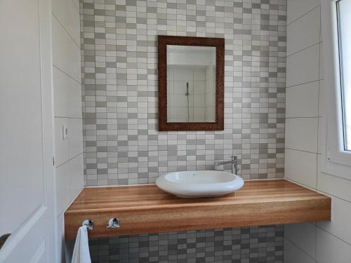 a bathroom with a sink and a mirror at Alkyon Villas in Sivota