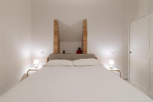 A bed or beds in a room at Case Baldelli La Chiostrina