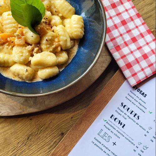 a plate of pasta on a table with a menu at ibis Aix en Provence in Aix-en-Provence