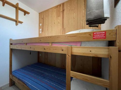 a bunk bed in a room with a sign on it at Appartement Montgenèvre, 1 pièce, 4 personnes - FR-1-330D-44 in Montgenèvre