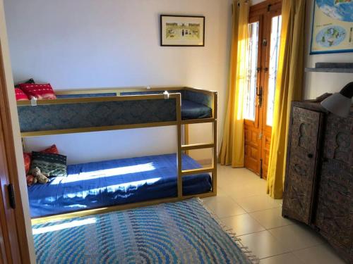 a room with two bunk beds and a rug at Casa Peppino in Teulada