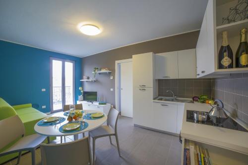 a kitchen and dining room with a table and chairs at Dreams Hotel Residenza Pianell 10 in Milan
