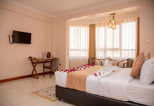 a bedroom with a large bed with flowers on it at Villa Grazia Luxury Hotel in Naivasha