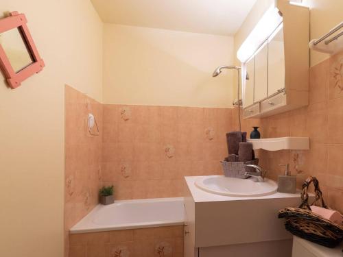 a bathroom with a sink and a bath tub at Maison Saint-Lary-Soulan, 4 pièces, 6 personnes - FR-1-296-291 in Saint-Lary-Soulan