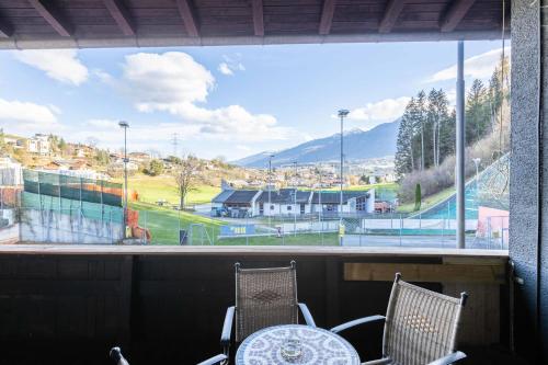 a large window with a view of a tennis court at The Art and Sporthotel in Innsbruck