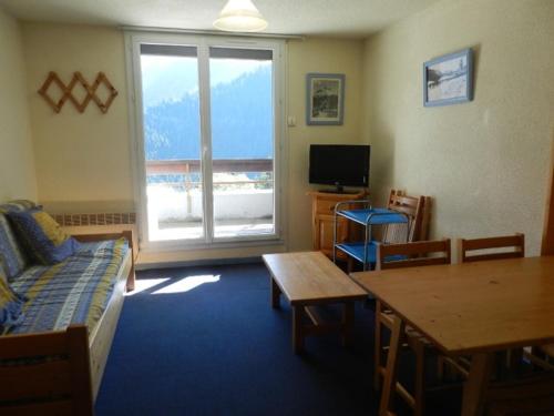 a living room with a couch and a table at Appartement Le Pleynet, 1 pièce, 4 personnes - FR-1-557A-16 in La Ferrière