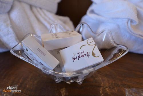 a glass bowl with twoentedented boxes in it at Nymfes Hotel in Kato Loutraki