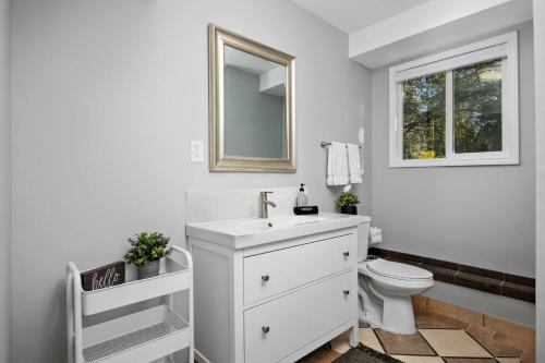 a white bathroom with a sink and a toilet at Springwater Escape in Gresham