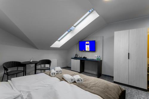 a bedroom with a large bed with towels on it at Pensjonat Śnieżka SPA in Karpacz
