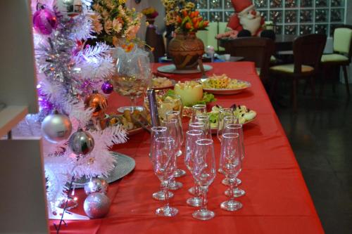 a table with wine glasses on a red table cloth at Pousada do Marujo in Rio das Ostras