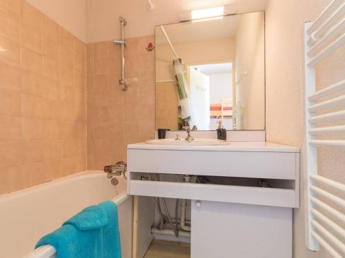 ein Badezimmer mit einem Waschbecken, einer Badewanne und einem Spiegel in der Unterkunft Appartement Montgenèvre, 2 pièces, 6 personnes - FR-1-330D-70 in Montgenèvre