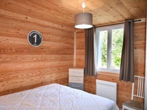 une chambre avec un lit et une horloge au mur dans l'établissement Charmant appartement au calme avec wifi et cuisine équipée - FR-1-266-164, à Montgenèvre