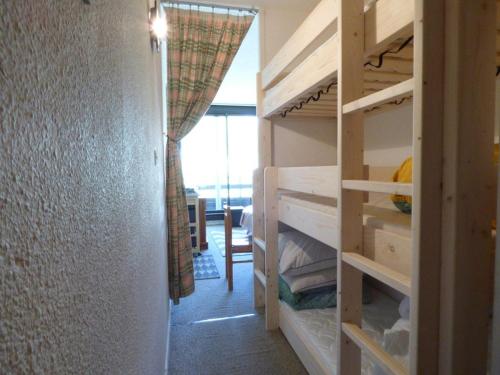 a bedroom with bunk beds and a room with a window at Studio Arette, 1 pièce, 5 personnes - FR-1-602-67 in Arette