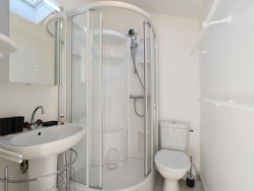 a bathroom with a shower and a toilet and a sink at Maison Les Portes-en-Ré, 5 pièces, 6 personnes - FR-1-434-70 in Les Portes