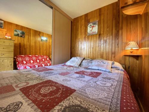 une chambre avec un lit avec une couette dessus dans l'établissement Appartement cosy 6 pers, Praz-sur-Arly, navette gratuite, parking, animaux admis - FR-1-603-43, à Praz-sur-Arly