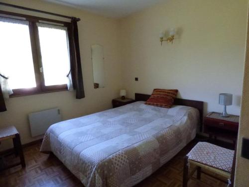 une chambre avec un grand lit et deux fenêtres dans l'établissement Agréable 2 pièces + cabine - 5 pers, balcon exposé sud - FR-1-458-133, au Grand-Bornand