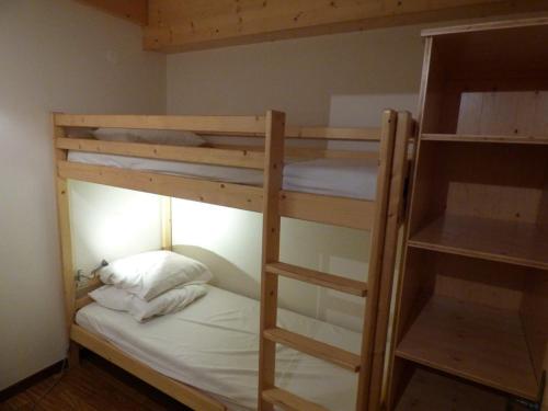 a bedroom with two bunk beds with white sheets at Appartement Le Grand-Bornand, 6 pièces, 11 personnes - FR-1-458-137 in Le Grand-Bornand