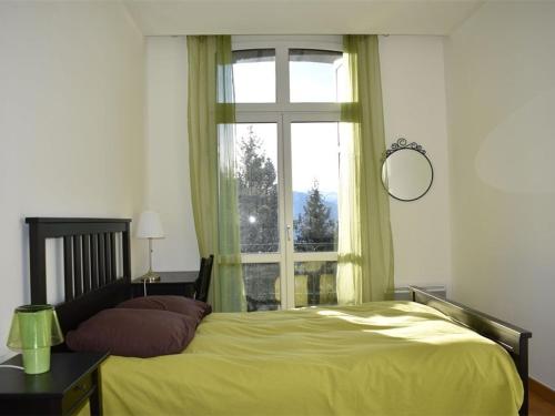 a bedroom with a yellow bed and a window at Appartement Font-Romeu-Odeillo-Via, 5 pièces, 9 personnes - FR-1-580-37 in Font-Romeu-Odeillo-Via