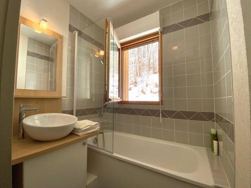 a bathroom with a sink and a tub and a window at Appartement Barèges, 2 pièces, 4 personnes - FR-1-403-97 in Barèges