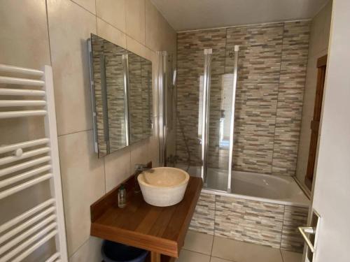 a bathroom with a sink and a bath tub at Appartement Les Angles, 2 pièces, 4 personnes - FR-1-295-169 in Les Angles
