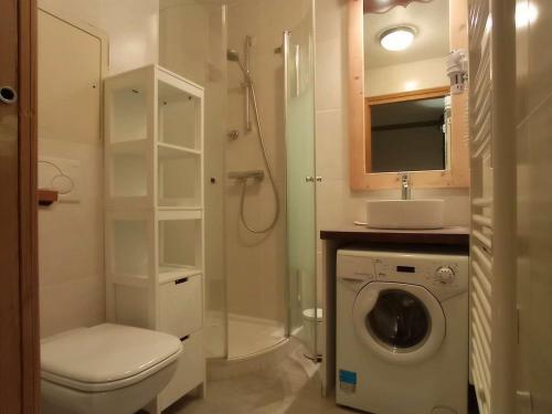 a bathroom with a toilet a sink and a washing machine at Appartement rénové chaleureux et moderne, 120m², 10-12 pers, accès direct aux pistes, stationnement inclus - FR-1-545-20 in Val Thorens