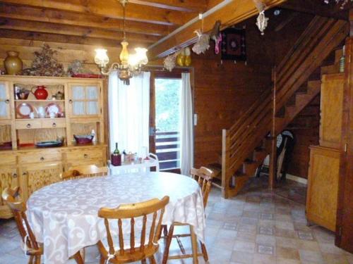 un comedor con mesa y sillas y una escalera en Chalet Arette, 4 pièces, 6 personnes - FR-1-602-80, en Arette