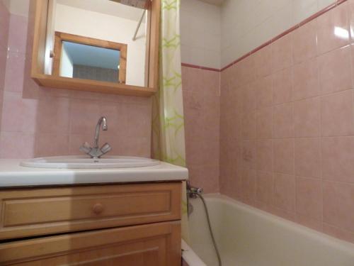 a bathroom with a sink and a bath tub at Studio Le Grand-Bornand, 1 pièce, 4 personnes - FR-1-458-100 in Le Grand-Bornand