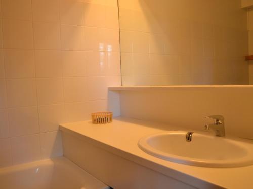 une salle de bain avec un lavabo et un miroir dans l'établissement Appartement 3P, 7 pers, proche pistes et commerces, cœur du village, Arc 1800 - FR-1-411-698, à Bourg-Saint-Maurice