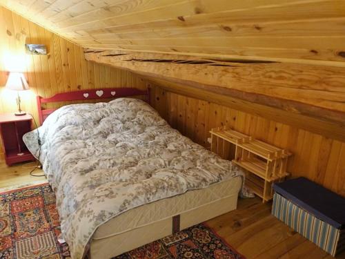 a bedroom with a bed in a wooden room at Chalet Arêches-Beaufort, 4 pièces, 10 personnes - FR-1-342-224 in Beaufort