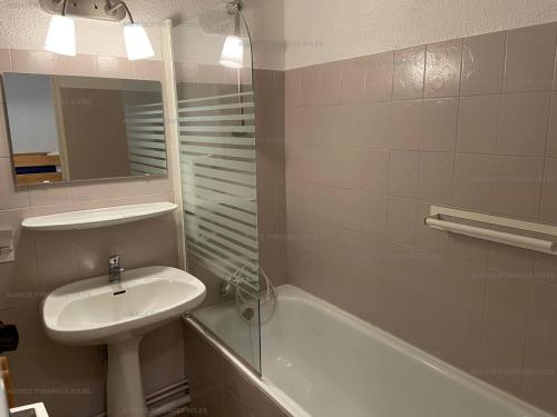 La salle de bains est pourvue d'un lavabo, d'un miroir, d'une baignoire et d'un haut de gamme. dans l'établissement Studio Les Angles, 1 pièce, 3 personnes - FR-1-295-131, aux Angles